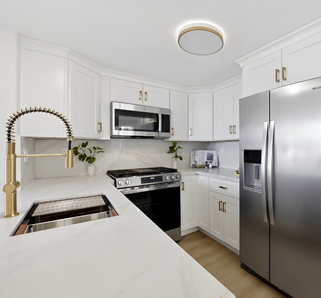 Finished white kitchen remodel with brass fixtures in Del Mar