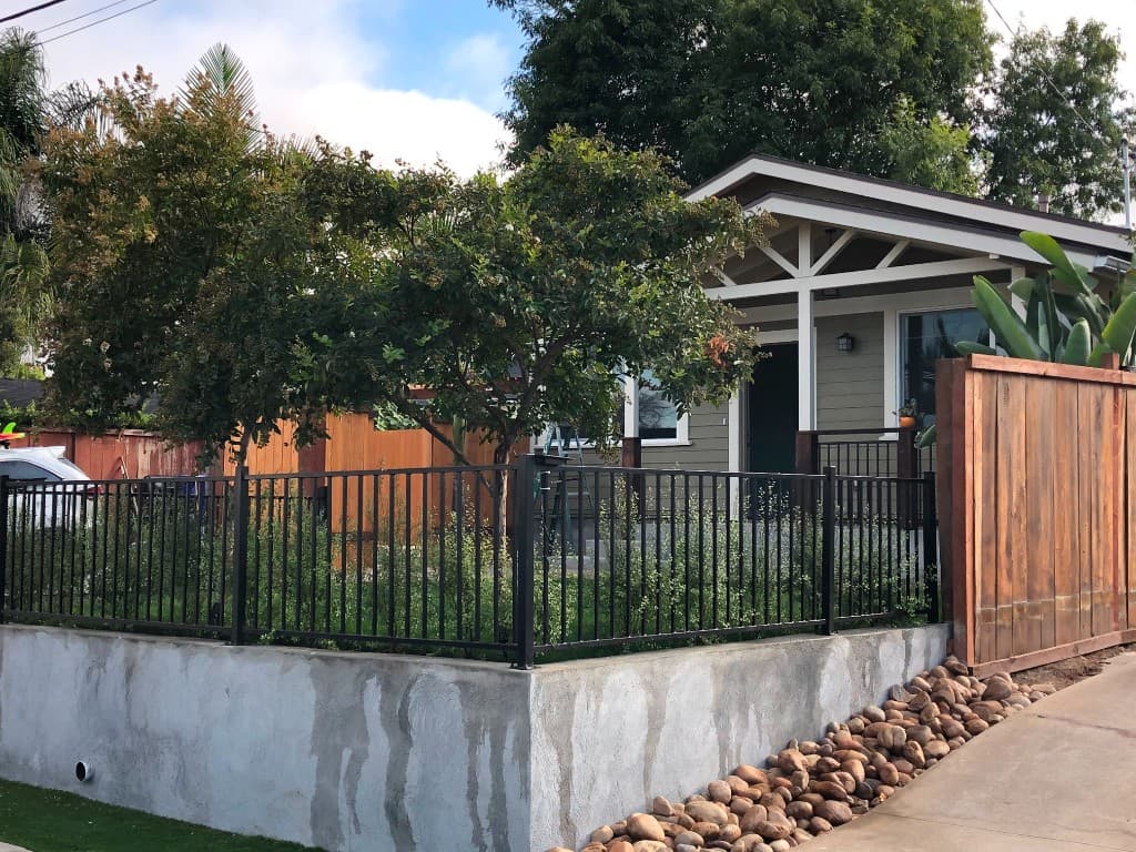 Completed backyard ADU with sage siding and porch in Del Mar